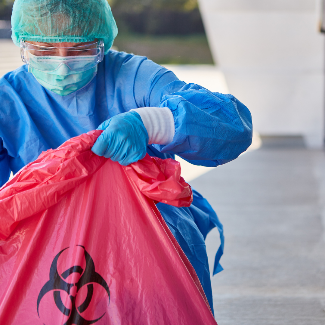 cleaning employee outside of a building handling biochemical substances