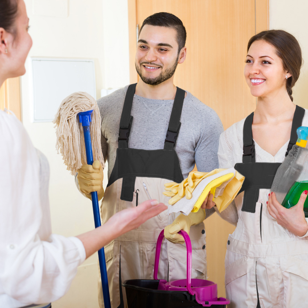 two cleaners consulting with their client before starting their job